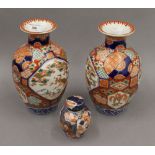 A pair of 19th century Japanese Imari decorated vases together with an Imari tea caddy.