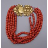 A string of coral beads with an unmarked 18 ct gold clasp. 37 cm long.