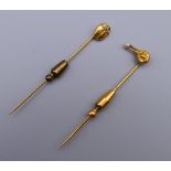 An unmarked gold bird form stick pin and a scarab beetle form stick pin. The former 7 cm high. 6.