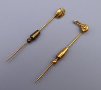 An unmarked gold bird form stick pin and a scarab beetle form stick pin. The former 7 cm high. 6.