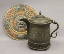 A large Tibetan brass teapot and an Indian brass charger. The former 31 cm high.