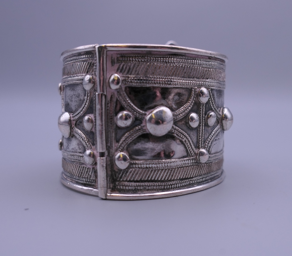 Three Eastern white metal bangles, two probably unmarked silver. The largest 12.5 cm diameter. - Image 6 of 14