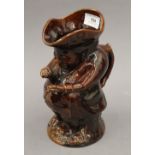 A treacle glaze snuff taker Toby jug. 24 cm high.