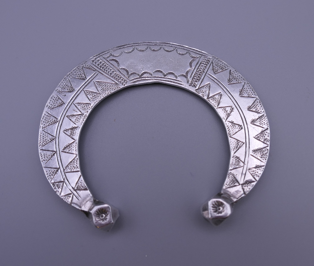 Three Eastern white metal bangles, two probably unmarked silver. The largest 12.5 cm diameter. - Image 2 of 14