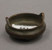 A Chinese miniature bronze censer. 5.5 cm diameter.