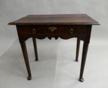 An 18th century oak single drawer side table. 76 cm wide.