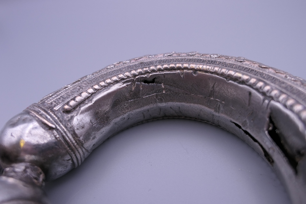 Three Eastern white metal bangles, two probably unmarked silver. The largest 12.5 cm diameter. - Image 12 of 14