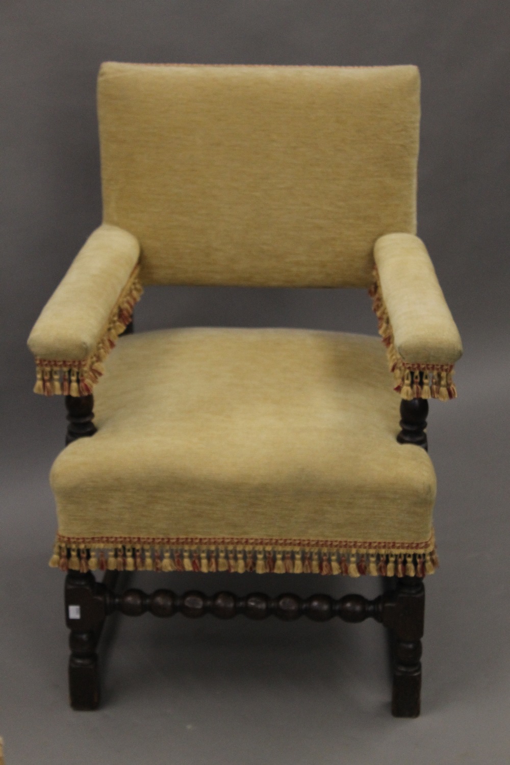An 18th century style upholstered open armchair. 66 cm wide.