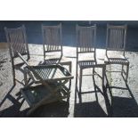 A set of four teak garden chairs and a drinks trolley.