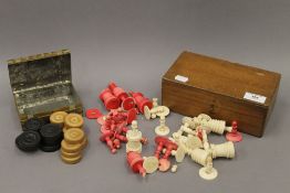 A 19th century red and white ivory carved chess set together with a wooden draughts set contained