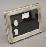 A silver photograph frame, hallmarked Birmingham 2005. 18 cm wide.