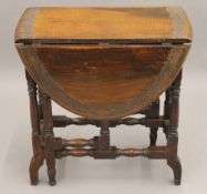 An Eastern carved hardwood drop leaf table. 61 cm wide.