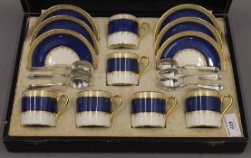 A cased set of six Crown Devon Fielding 2354 coffee cans, saucers, with silver teaspoons,