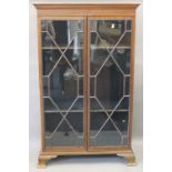 An Edwardian mahogany display cabinet with two astragal glazed doors. 118.5 cm wide.
