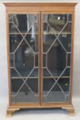 An Edwardian mahogany display cabinet with two astragal glazed doors. 118.5 cm wide.