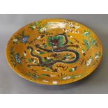 A large Chinese porcelain dish decorated with a dragon. 45 cm diameter.