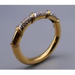 An 18 ct gold diamond bangle. 7 cm wide. 30.78 grammes total weight.