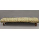 A Victorian upholstered long footstool. 108 cm long.