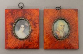 A pair of red framed miniatures. 9.5 cm high.