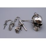 A sterling silver skull on chain.