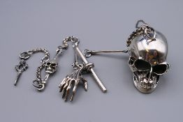 A sterling silver skull on chain.