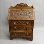 A Victorian carved oak bureau. 80 cm wide.