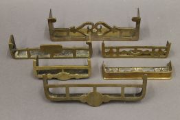 Six Victorian miniature brass fenders. The largest 17.5 cm wide.