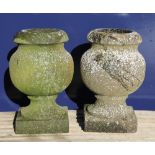 A small pair of stone urns. 30 cm high.