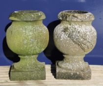 A small pair of stone urns. 30 cm high.