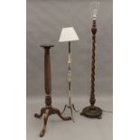 A barley twist standard lamp, another standard lamp and a torchere. The former 180 cm high overall.