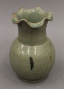 A Chinese celadon vase with kiln marks. 16.5 cm high.