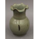 A Chinese celadon vase with kiln marks. 16.5 cm high.