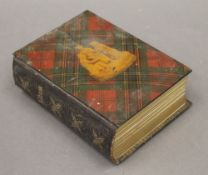 A Victorian Tartanware album. 16 cm high.