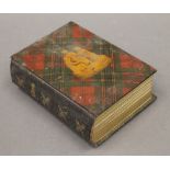 A Victorian Tartanware album. 16 cm high.