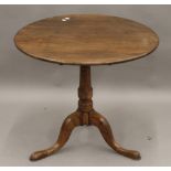 A Georgian oak tilt top tripod table. 77 cm diameter.