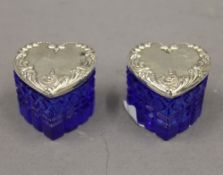 A pair of silver topped heart shaped glass boxes. 3.5 cm high.