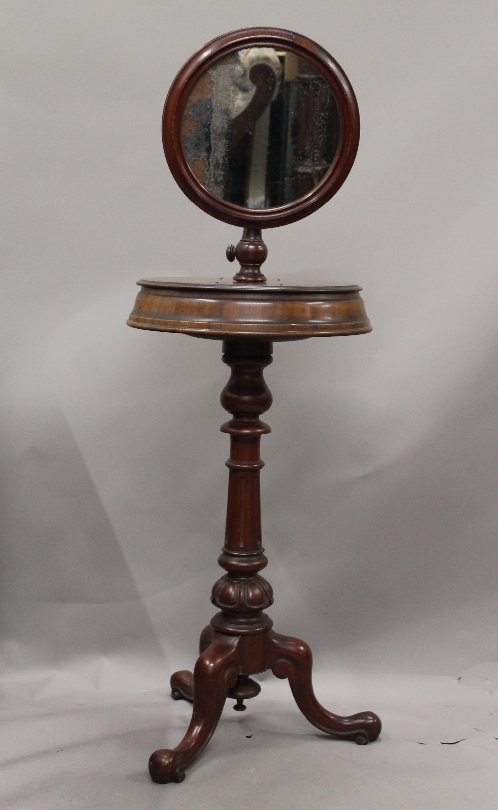A Victorian mahogany shaving stand, with original mirror. 132 cm high.