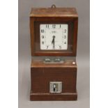A vintage clocking-in clock. 69 cm high.