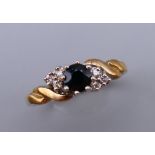 A 9 ct gold diamond and sapphire ring. Ring size O. 2.6 grammes total weight.