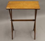 A Victorian oak folding campaign side table. 61 cm wide.