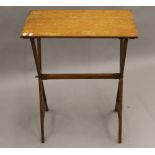 A Victorian oak folding campaign side table. 61 cm wide.