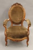 A Victorian carved walnut open armchair.