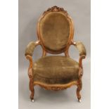 A Victorian carved walnut open armchair.