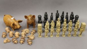 A collection of model pigs and a chess set.
