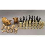 A collection of model pigs and a chess set.