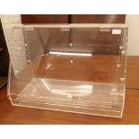 A perspex display case. 60.5 cm wide, 40.5 cm high, 30 cm deep.