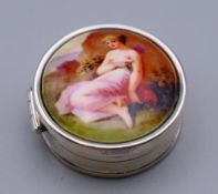 A silver pill box depicting a young lady. 2.5 cm diameter.