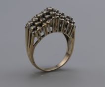 A 9 ct gold ring set with forty-five diamonds. Ring size O/P. 6.8 grammes total weight.