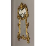 A large modern gilt framed mirror decorated with cherubs. 155 cm high.