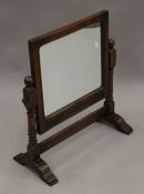 A carved oak dressing table mirror. 53 cm wide.